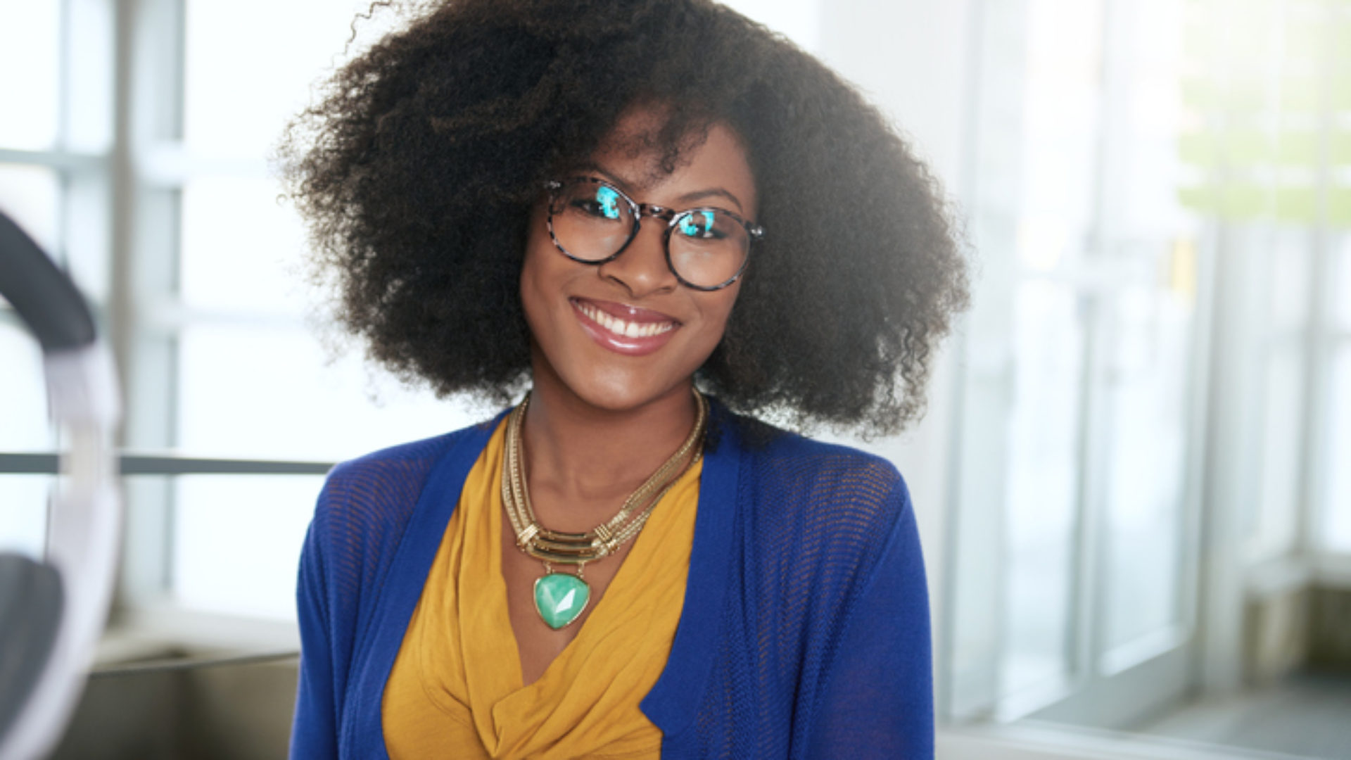 Portrait of a smiling woman with an afro at the